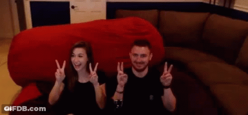 Man And Woman Giving Peace Signs GIF