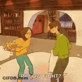 Man And Woman Having Pillow Fight GIF