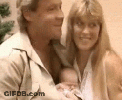 Man And Woman Holding Baby Smiling GIF