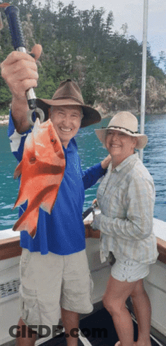 Man And Woman Holding Fish On Boat GIF