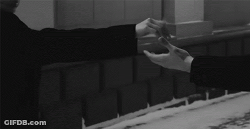 Man And Woman Holding Hands At Brick Wall GIF