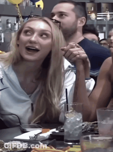 Man And Woman Holding Hands At Table GIF