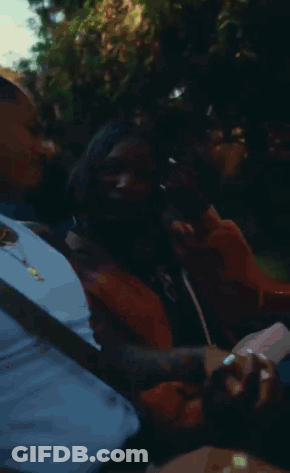 Man And Woman Holding Hands In Car Laughing GIF