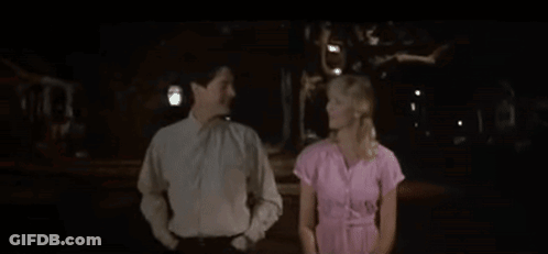 Man And Woman Holding Hands In Dark Room GIF