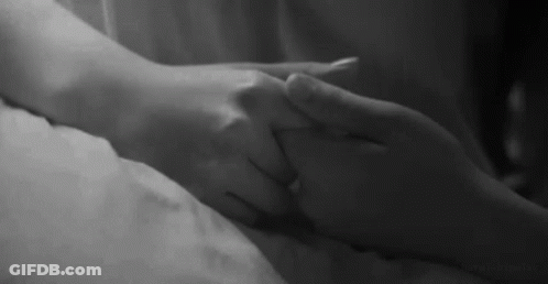 Man And Woman Holding Hands On Bed GIF