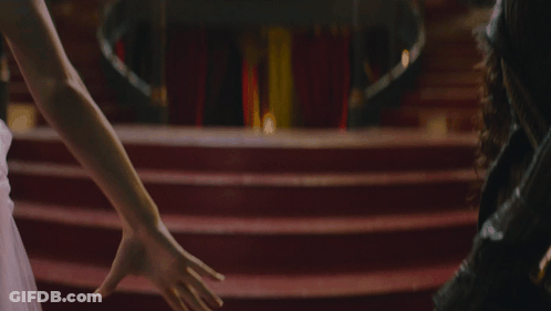 Man And Woman Holding Hands On Red Carpet GIF