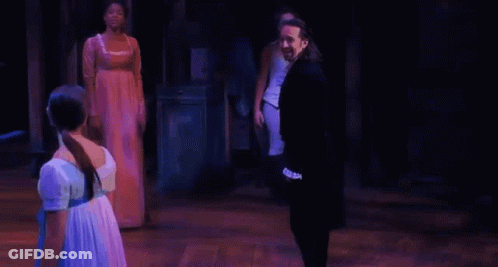 Man And Woman Holding Hands On Stage GIF
