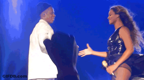 Man And Woman Holding Hands On Stage GIF