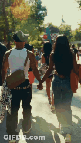 Man And Woman Holding Hands Walking Down Street GIF