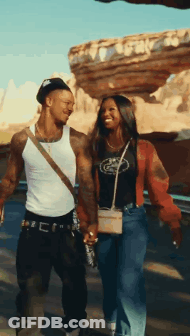 Man And Woman Holding Hands Walking In Desert GIF