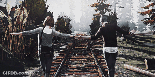 Man And Woman Holding Hands Walking On Train Tracks GIF