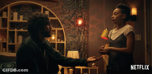 Man And Woman Holding Hands With Netflix Logo GIF