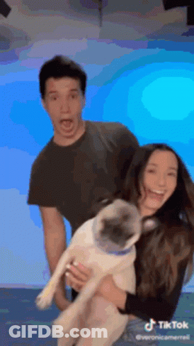 Man And Woman Holding Pug GIF