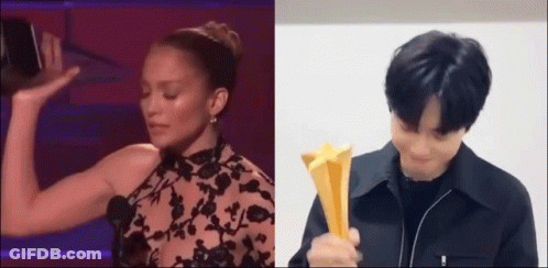 Man And Woman Holding Trophies On Stage GIF