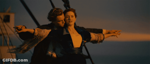 Man And Woman Hugging By Ocean GIF