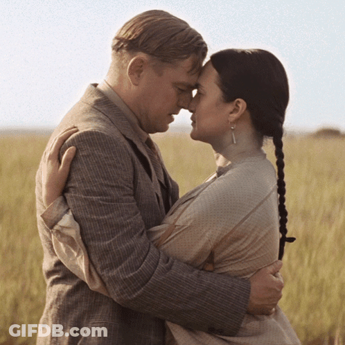 Man And Woman Hugging In Field GIF