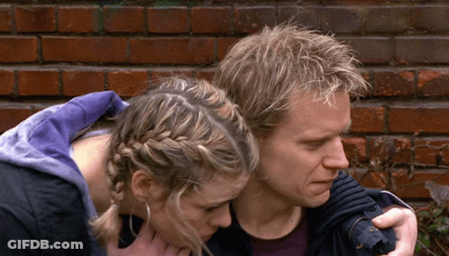Man And Woman Hugging In Front Of Brick Wall GIF