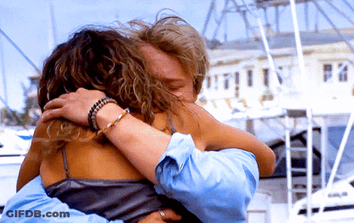 Man And Woman Hugging In Front Of Building Saying Pa GIF