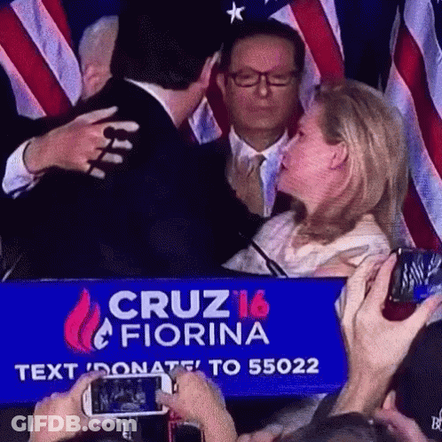 Man And Woman Hugging In Front Of Cruz 16 Fiorina Sign GIF
