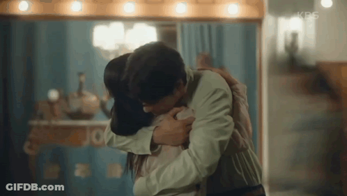 Man And Woman Hugging In Front Of Mirror GIF