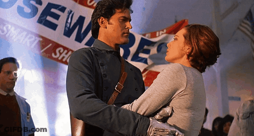 Man And Woman Hugging In Front Of Sewer Banner GIF