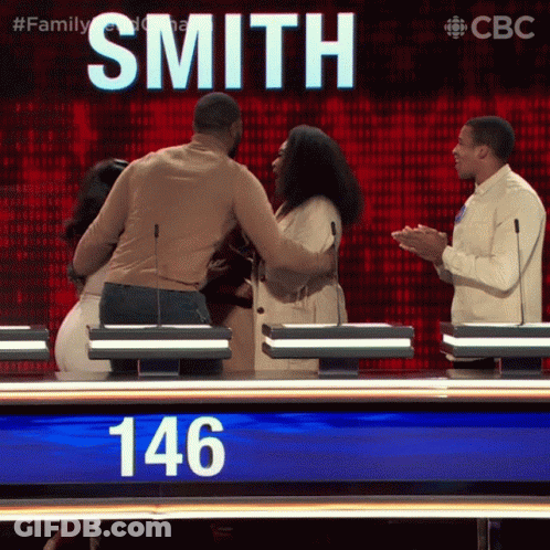 Man And Woman Hugging In Front Of Smith Sign GIF