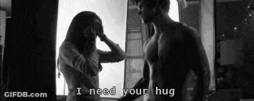 Man And Woman Hugging In Front Of Window GIF