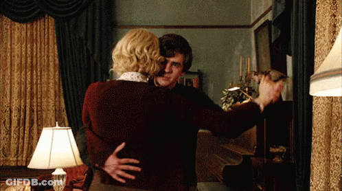 Man And Woman Hugging In Living Room With Lamp GIF