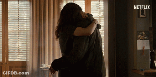 Man And Woman Hugging In Room With Netflix Logo GIF