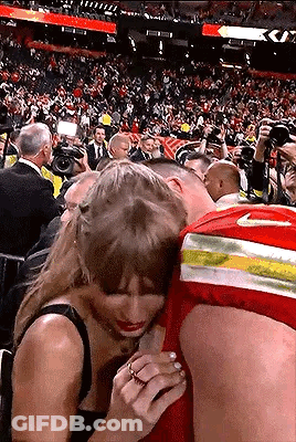 Man And Woman Hugging In Stadium GIF