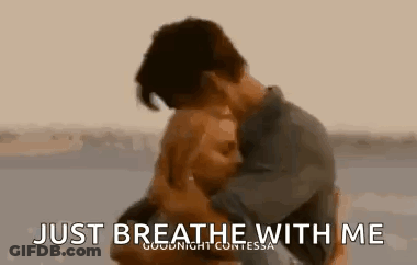 Man And Woman Hugging On Beach Saying Just Breathe With Me GIF