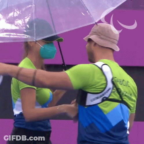 Man And Woman Hugging Under Umbrella Paralympic GIF