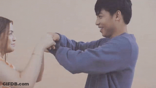 Man And Woman Hugging Woman In Tie Dye GIF