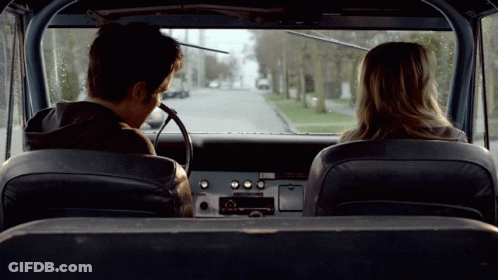 Man And Woman In Back Seat Of Car Looking Out Window GIF
