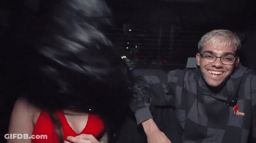 Man And Woman In Back Seat Of Car Wearing Tommy Jeans Sweatshirt GIF