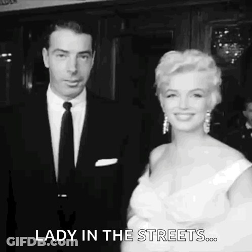 Man And Woman In Black And White Standing Together GIF