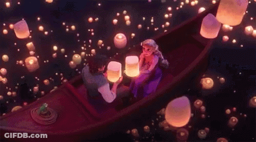 Man And Woman In Boat Looking At Floating Lanterns GIF