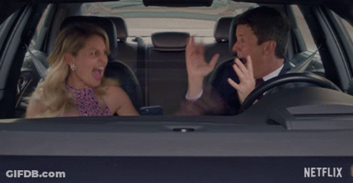 Man And Woman In Car With Netflix Logo GIF