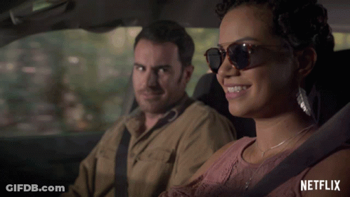 Man And Woman In Car With Netflix Logo GIF