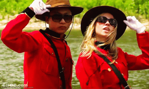 Man And Woman In Cowboy Hats And Sunglasses Next To Water GIF