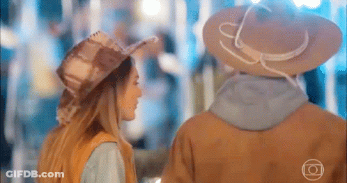 Man And Woman In Cowboy Hats Holding Hands GIF