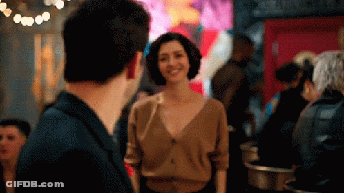 Man And Woman In Crowded Room GIF