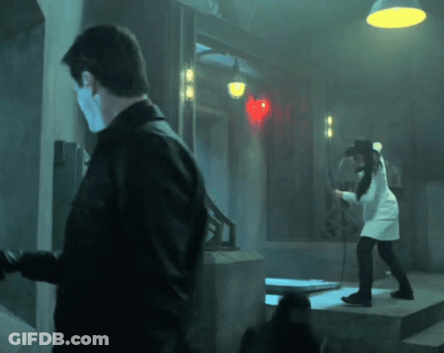 Man And Woman In Dark Room With Red Heart GIF
