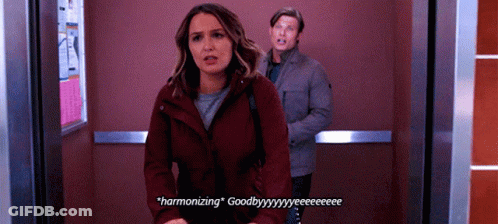 Man And Woman In Elevator Woman Saying Harmonizing GIF