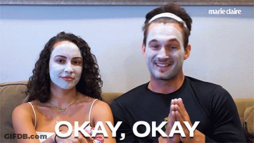 Man And Woman In Face Masks Saying Okay Okay GIF