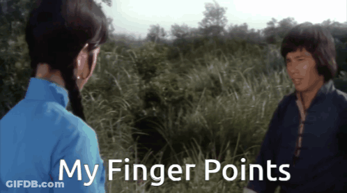 Man And Woman In Field Saying My Finger Points GIF