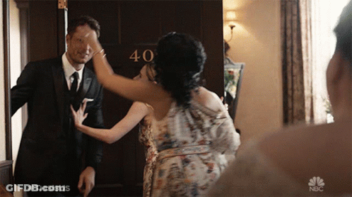 Man And Woman In Front Of 40 Door GIF