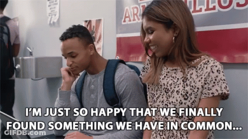 Man And Woman In Front Of Art Sign GIF