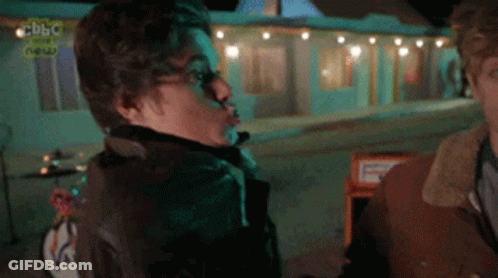 Man And Woman In Front Of BBC Building GIF