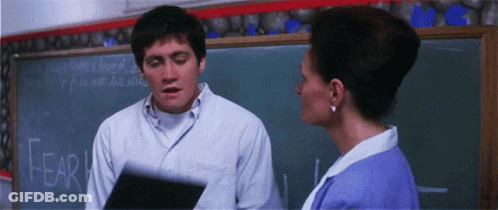 Man And Woman In Front Of Blackboard Saying Fear GIF